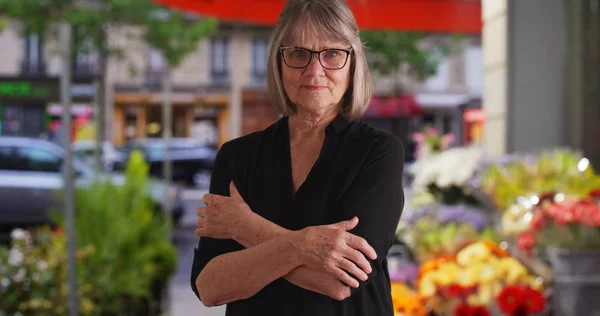 Serious Senior Woman Arms Crossed Looking Sternly City Flower Shop — Stock Photo, Image