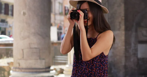 Closeup of Asian millennial photographer taking pictures in Rome Italy