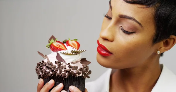 チョコレートとイチゴのファンシーなデザート ケーキを眺め黒人女性 — ストック写真