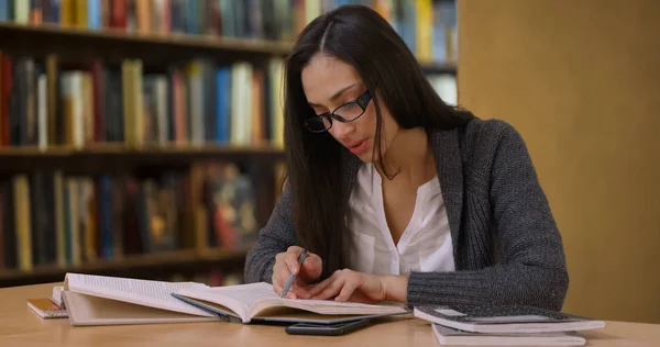 Attractive Hispanic Woman Glasses Reads Book Library — Stock Photo, Image