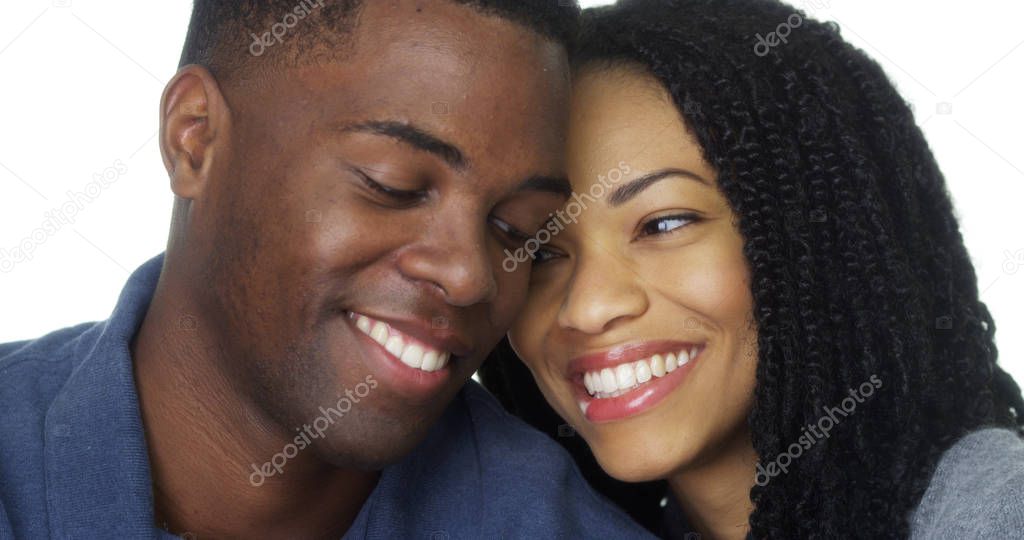 African American couple in love smiling and looking at camera