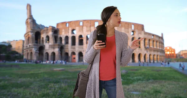 Attractive Latina woman is lost in Rome uses app on smart phone for directions
