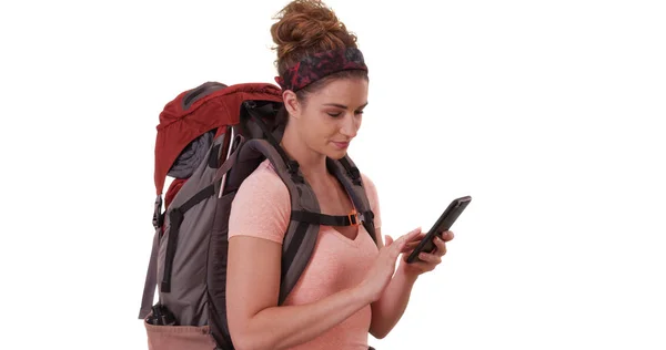 Portrait of Caucasian woman wearing backpack sending text on white background