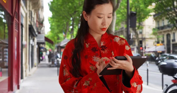 Close up of millennial woman typing on portable tablet computer in Paris France