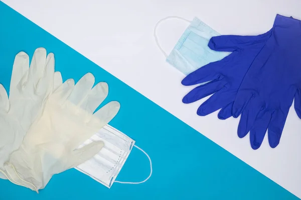 Medicine face mask and medical latex gloves on two-color background of blue and white. Concept of health care virus protection, COVID-19 pandemic, global quarantine. Layout, top view, flatly