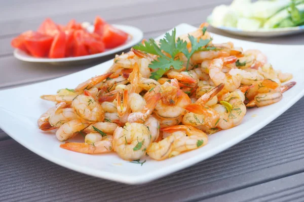 Fried shrimps on a white plate with herbs — Stock Photo, Image