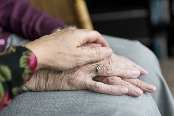 A old couple holding hands of each other romance