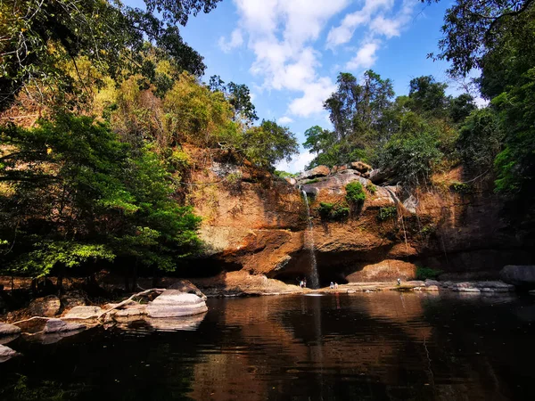 Large pool with water cascading down an over hang in Khao Yai , Thailand
