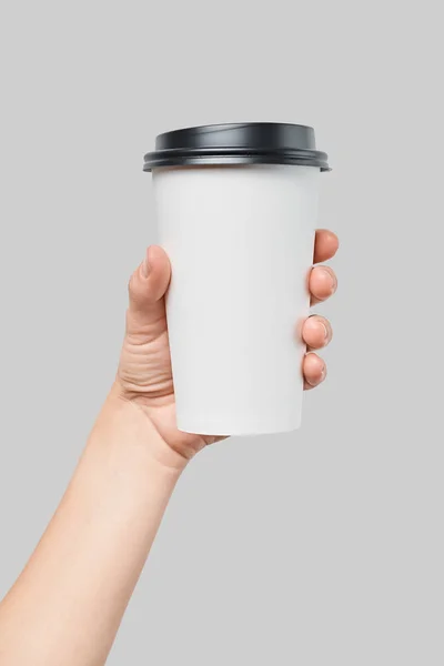 Mockup of womens hand holding white paper large size cup with black cover — Stock Photo, Image