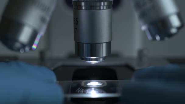 Microscope with metal lens at laboratory. — Stock Video