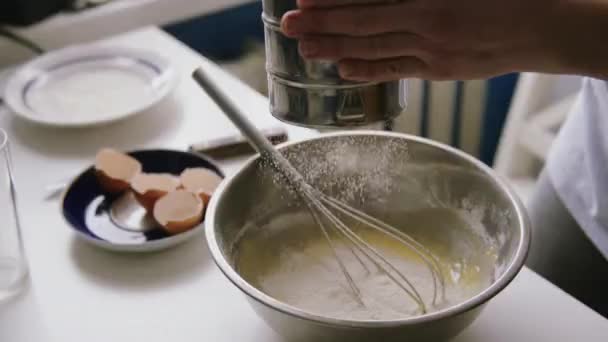 Woman sifting flour in a bowl — Stock Video