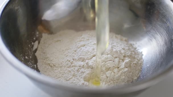 Falling egg into bowl with flour. — Stock Video