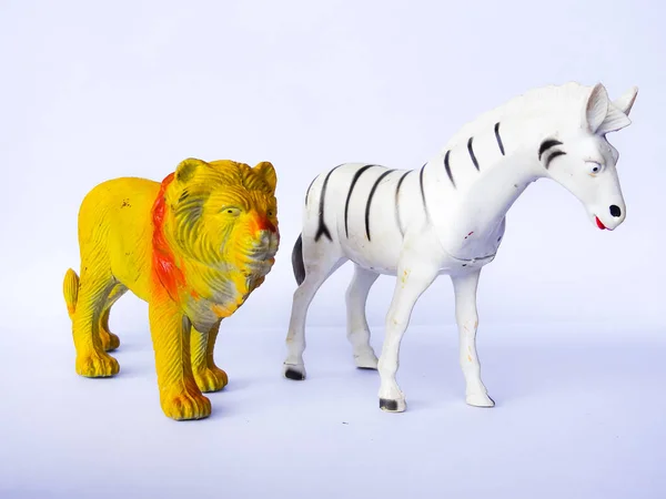 lion and zebra animal toy on white background