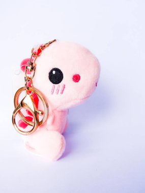 Beyaz arka planda pembe dinozor bebeği