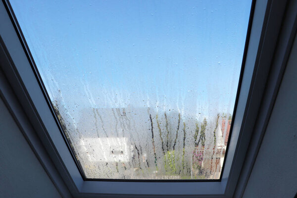 Roof window with condensation and high humidity in the room.