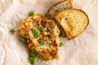 Taze kızarmış domuz eti, yeşil soğan ve ketçap ile serpilir. Ambalaj kağıdı düzenleme