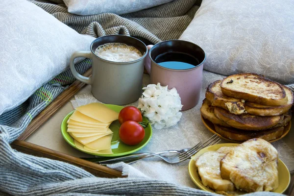Lezzetli kahvaltı tost ve büyük bir fincan kahve ile yatakta