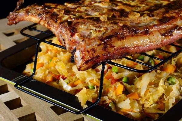 stock image Grilled meat. Grilled pork ribs with braised cabbage.