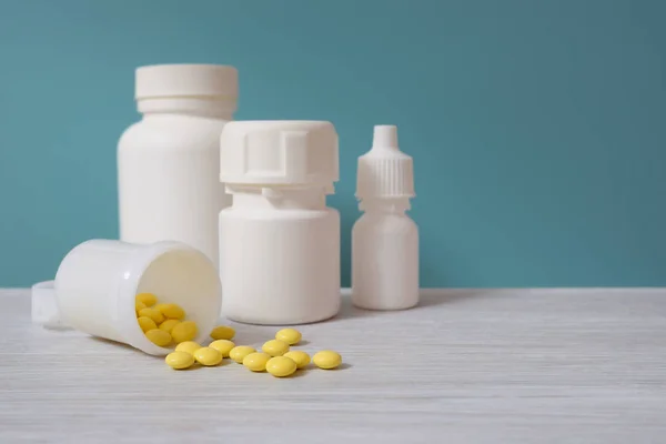 Medication. Yellow pills and medicine jars. Blue background.