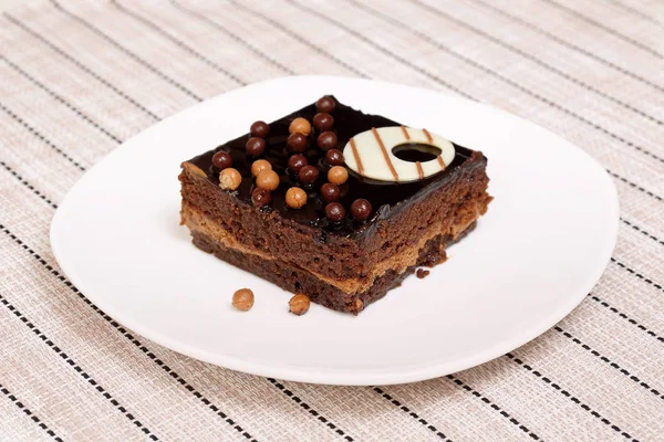 Chocolate cake. Slice of sponge cake on a white plate.