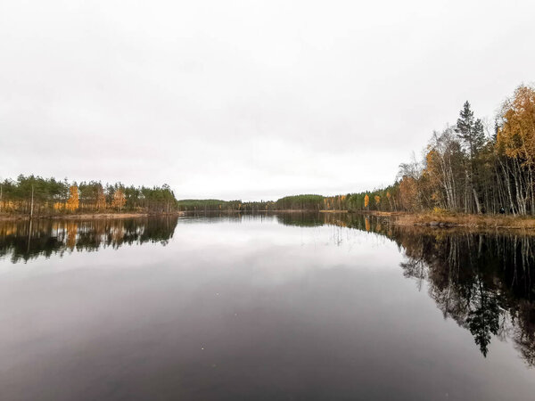 reflections of the trees on the lake of the Repovesi National Park