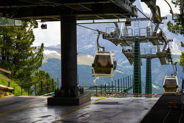 cabin of Cable car lift arrive to top of the mountain with place of rest, restaurant and hotel in summer sunny day. Selva di Val Gardena Trentino, Alto Adige, south tyrol, Dolomites. Italy.