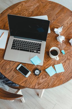 Ofis İşyeri dizüstü bilgisayar, kahve fincanı ve ahşap masa üstünde smartphone