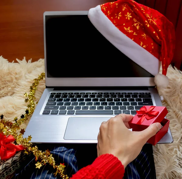 Noel çevrimiçi alışveriş merkezi manzarası. Kırmızı kutu ellerinde. Kış tatili satışları