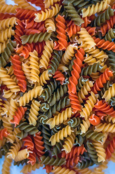 Gruo de fusilli multicolor en toma abstracta