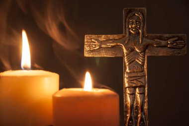 Katolik Hıristiyan haçı mumlarla ve tütsü dumanıyla aydınlanır.