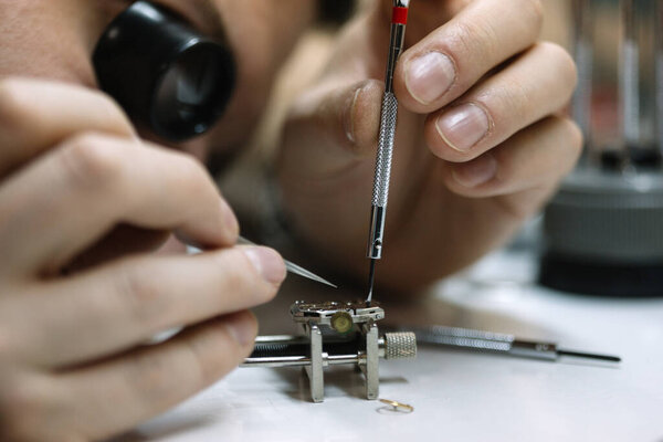 Watchmaker is repairing the wristwatch, mechanical watch