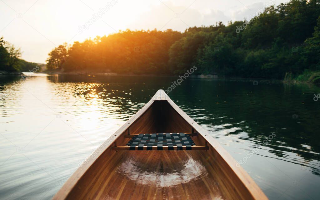 Canoe bow deck on the sunset lake