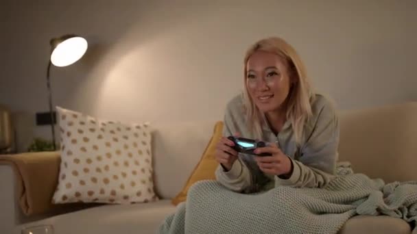 Focused Pretty Southeast Asian Woman Playing Video Games On A Console — Stock Video