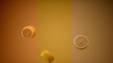 Taze limon dilimleri havada asılı uçuyor ve düşüyor.