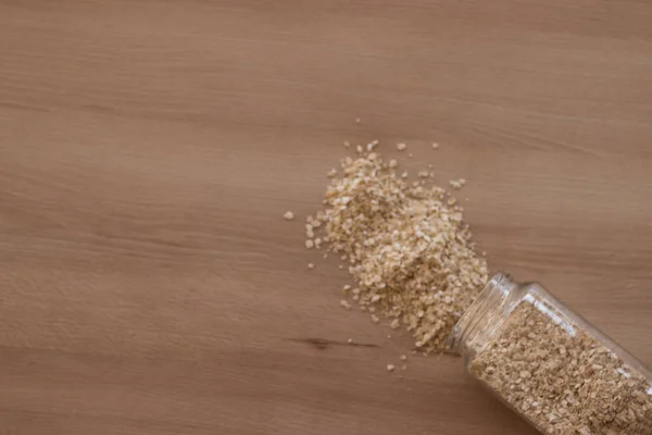 stock image scattered oats on a wooden table