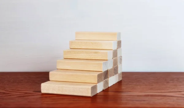 Wooden blocks as a staircase stacking. Career ladder concept for successful business development.