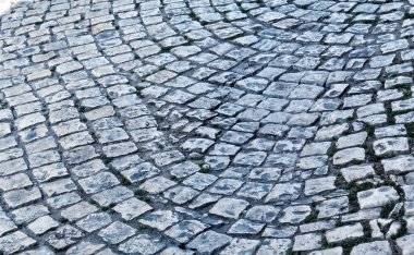 Eski kaldırım taşları, yakın plan. Döşeme taşı dokusu. Soyut yapılandırılmış arkaplan.