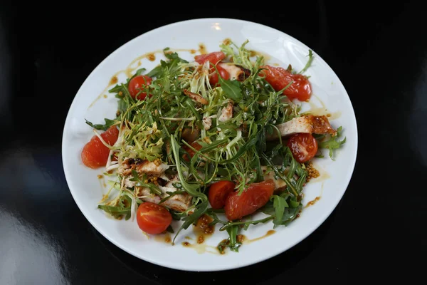 restaurant dish, green salad, cucumbers, red pepper, boiled meat, arugula, tomato and grapefruit, healthy food, close-up, for the menu