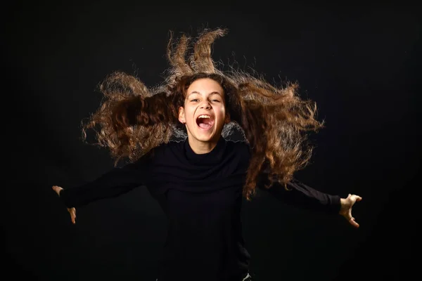 Retrato emocional de uma menina com cabelos longos encaracolados no fundo — Fotografia de Stock