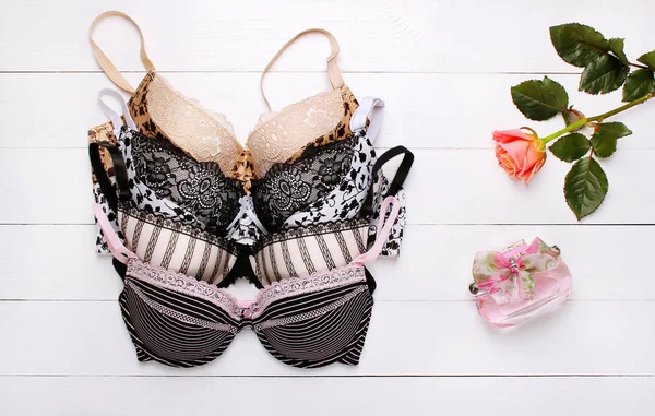 güzel seksi sütyen ve ahşap arka plan üzerinde parfüm