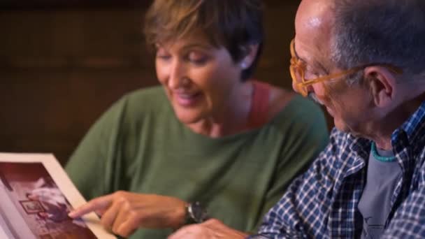 Loving Couple Grandparents Look Old Wedding Photo Album Remembering Mature — Stock Video