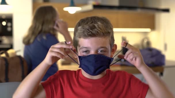 Caucasian Boy Puts Protective Mask Home Looking Camera First Day — Stock Video