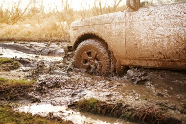 Kirli SUV su birikintileri ve kirli yakın çekimle off-road yapıyor. Off-road seyahati