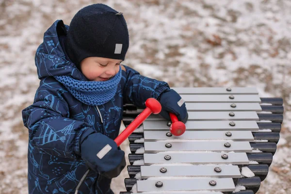 Little Boy Jumpsuit Hat Mittens Plays Musical Instrument Winter Park — Stock Photo, Image