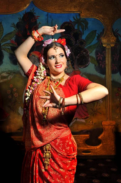 Photo of a woman in red in indian style.