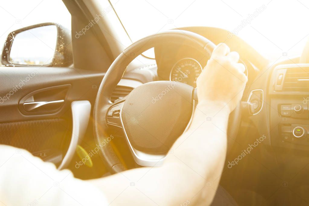 Man hands holding steering wheel 