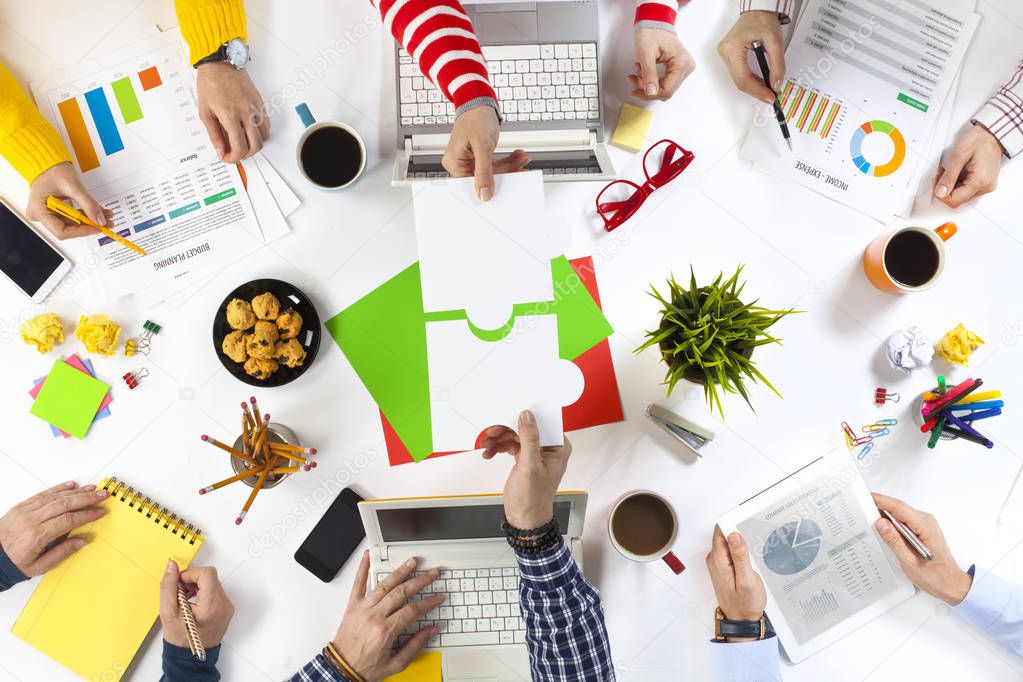 Business people assembling puzzle