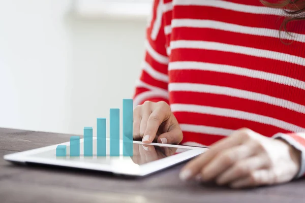 Woman analyzing graph on digital tablet — 스톡 사진