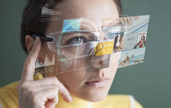 Woman in glasses with virtual screen — Stock Photo, Image