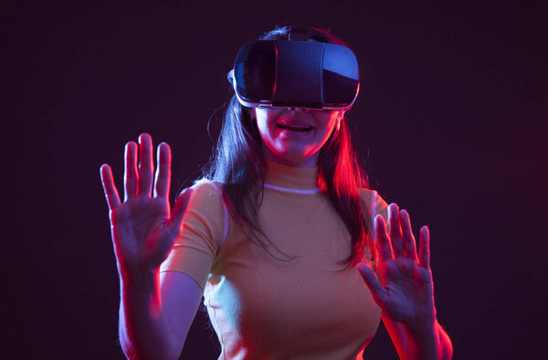 Young girl with VR goggles on head